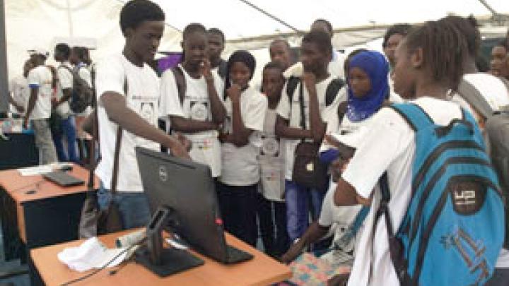 ICTP PhD student Khadim Mbacke War (left) at a math exhibit in Senegal