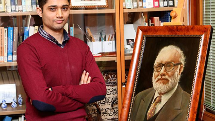 Sadiq Khan poses next to painting of ICTP founder Abdus Salam