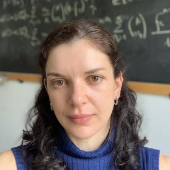 Picture of Debora in front of a black board